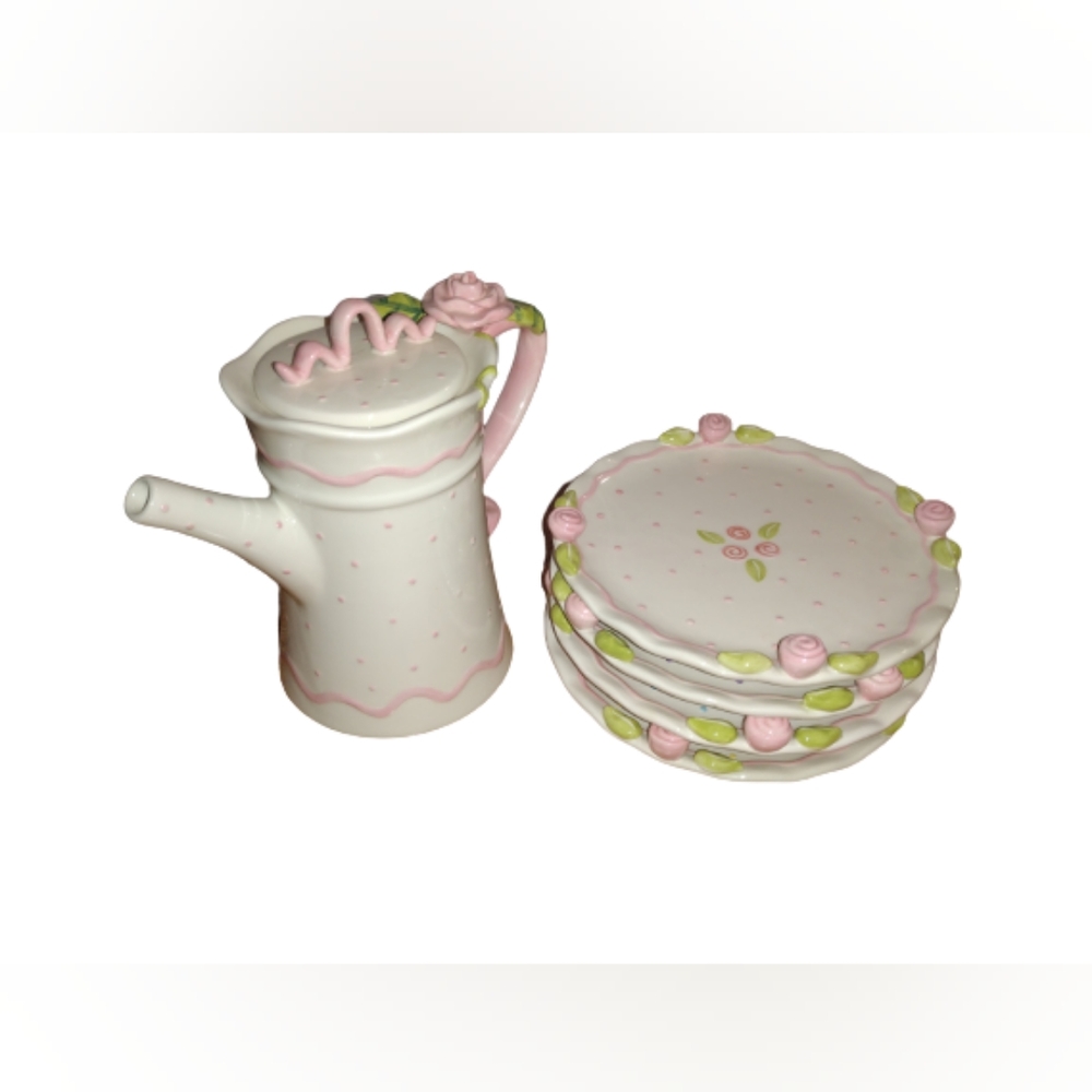 A really adorable white teapot and 4 white plates